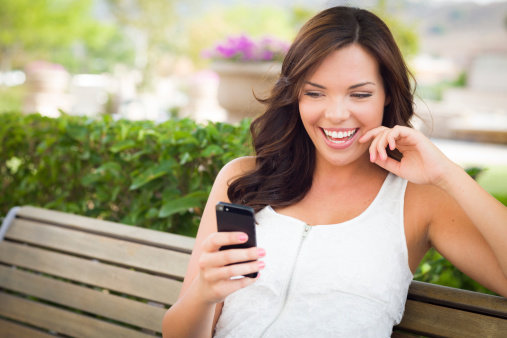 girl looking on her smartphone and smiling