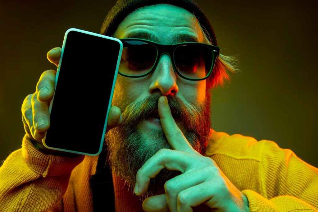 man with 8 Best iPhone Spy Apps on phone